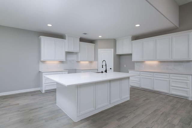 307 Grand Vw, Huntsville, TX 77340 - kitchen featuring white cabinetry, a kitchen island with sink, recessed lighting, and light wood finished floors