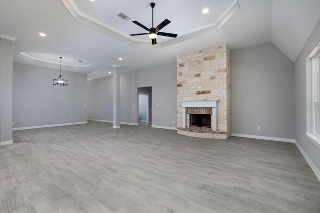 307 Grand Vw, Huntsville, TX 77340 - unfurnished living room with a raised ceiling, ceiling fan, light wood-style floors, a fireplace, and recessed lighting