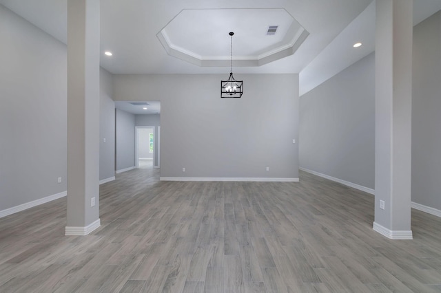 307 Grand Vw, Huntsville, TX 77340 - unfurnished dining area with a tray ceiling, wood finished floors, recessed lighting, a chandelier, and baseboards