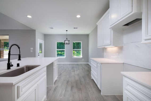 307 Grand Vw, Huntsville, TX 77340 - kitchen featuring a sink, light countertops, light wood-type flooring, white cabinetry, and recessed lighting
