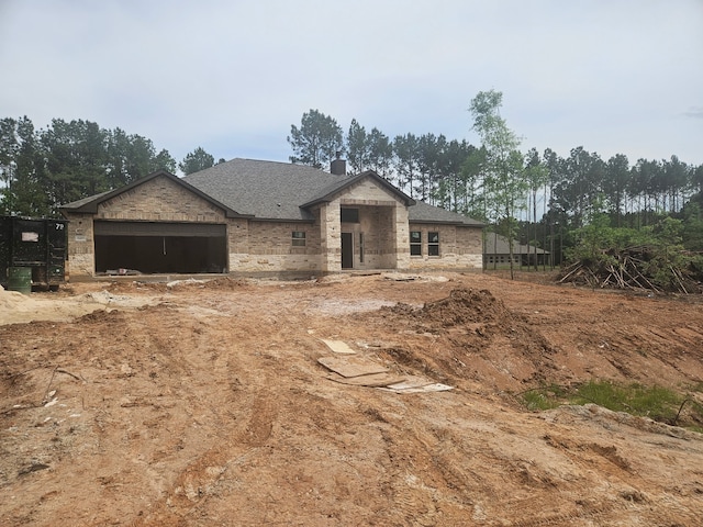 307 Grand Vw, Huntsville, TX 77340 - view of front of home with a garage, brick siding, a shingled roof, and a chimney