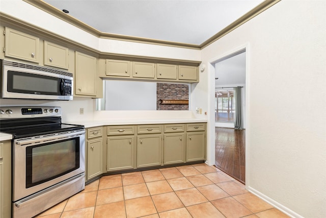 3336 Thornwood Way, Huntsville, TX 77340 - kitchen featuring stainless steel appliances, light countertops, light tile patterned floors, crown molding, and baseboards