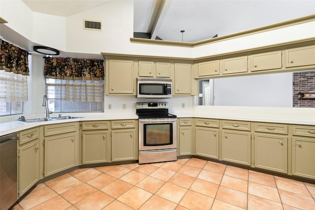 3336 Thornwood Way, Huntsville, TX 77340 - kitchen featuring appliances with stainless steel finishes, a sink, light countertops, light tile patterned floors, and lofted ceiling