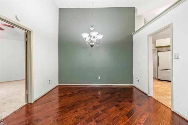 3336 Thornwood Way, Huntsville, TX 77340 - unfurnished dining area with wood finished floors, a chandelier, a ceiling fan, and baseboards