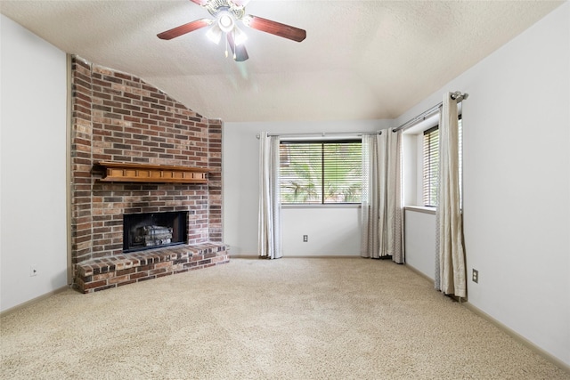 3336 Thornwood Way, Huntsville, TX 77340 - unfurnished living room featuring lofted ceiling, carpet flooring, a brick fireplace, a textured ceiling, and ceiling fan
