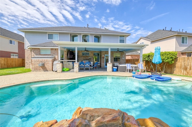 8210 Edenwood Dr, Spring, TX 77389 - back of property with area for grilling, ceiling fan, a fenced backyard, and an outdoor living space