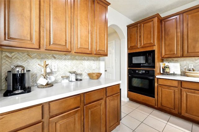8210 Edenwood Dr, Spring, TX 77389 - kitchen with black appliances, brown cabinets, light countertops, and decorative backsplash