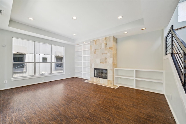 616 Lester St, Houston, TX 77007 - unfurnished living room with built in shelves, recessed lighting, a tile fireplace, baseboards, and wood finished floors