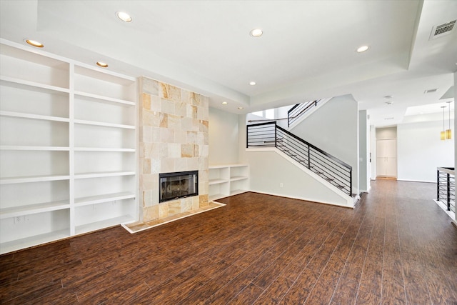 616 Lester St, Houston, TX 77007 - unfurnished living room featuring built in features, recessed lighting, stairway, wood finished floors, and a fireplace