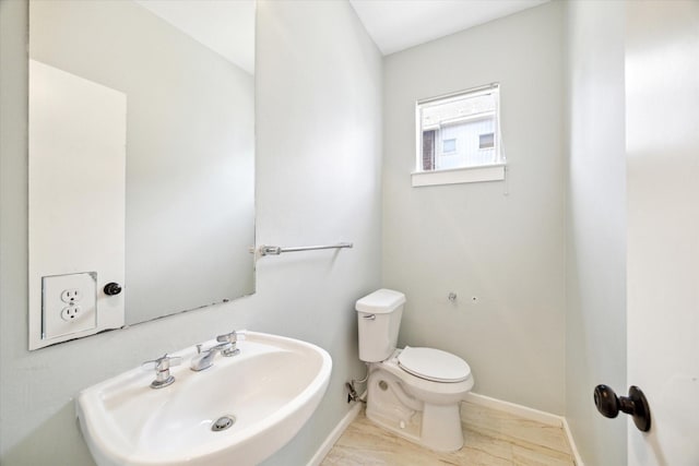 616 Lester St, Houston, TX 77007 - bathroom featuring a sink, toilet, baseboards, and wood finished floors