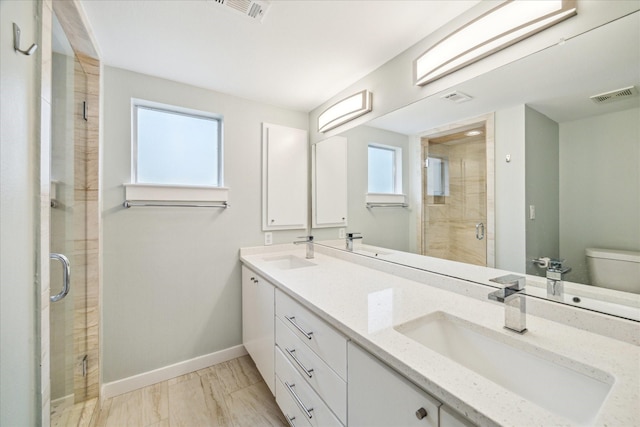 616 Lester St, Houston, TX 77007 - full bath featuring toilet, double vanity, a stall shower, and healthy amount of natural light