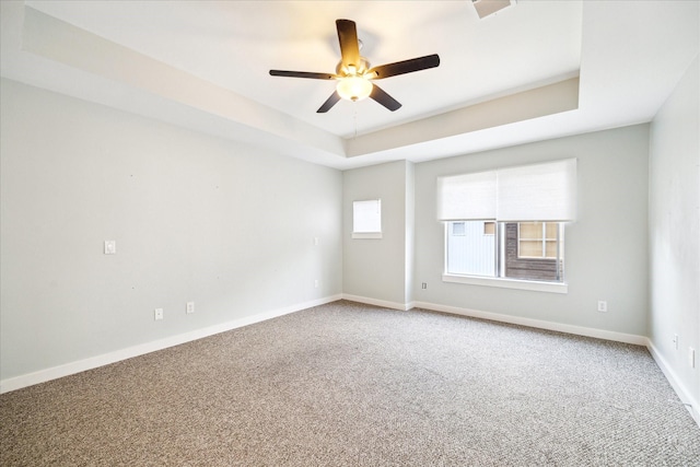 616 Lester St, Houston, TX 77007 - carpeted spare room featuring a tray ceiling, ceiling fan, and baseboards