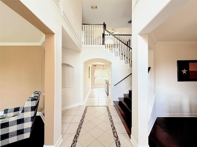 522 Chickory Field Ln, Pearland, TX 77584 - stairway featuring arched walkways, baseboards, and crown molding