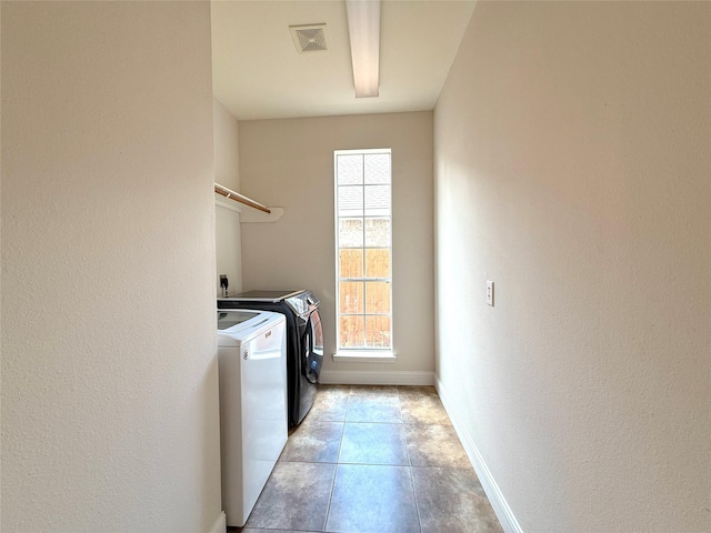 522 Chickory Field Ln, Pearland, TX 77584 - laundry area featuring washer and dryer, baseboards, light tile patterned floors, and a textured wall