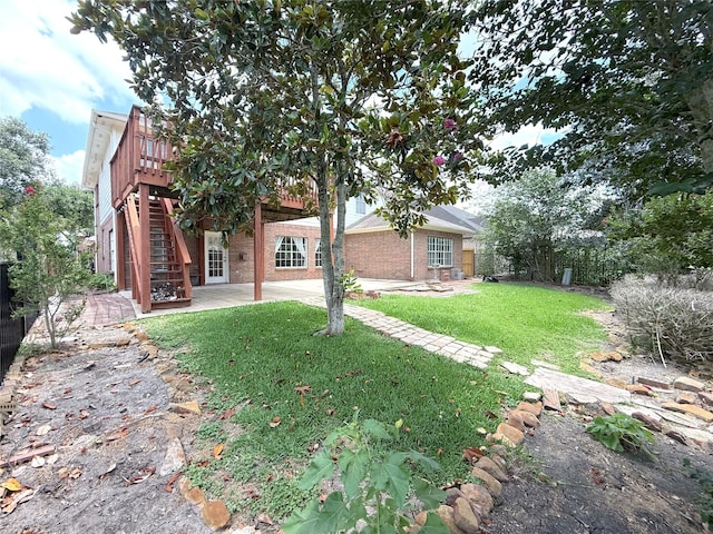 522 Chickory Field Ln, Pearland, TX 77584 - rear view of house featuring a deck, a patio, a yard, stairs, and brick siding