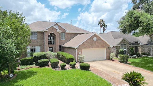 522 Chickory Field Ln, Pearland, TX 77584 - traditional-style home with brick siding, a garage, concrete driveway, and a front lawn