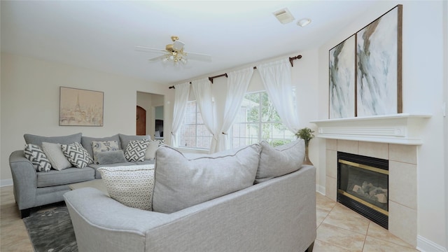522 Chickory Field Ln, Pearland, TX 77584 - tiled living room with a tiled fireplace, a ceiling fan, and baseboards