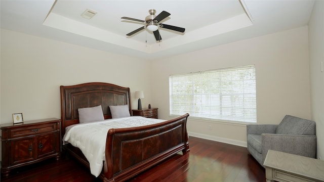 522 Chickory Field Ln, Pearland, TX 77584 - bedroom with a tray ceiling, dark wood-style flooring, baseboards, and ceiling fan