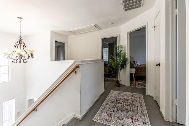 15135 Kamary Ln, San Antonio, TX 78247 - corridor with an upstairs landing, dark wood-style flooring, and a chandelier