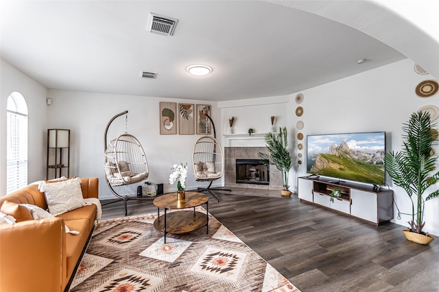 15135 Kamary Ln, San Antonio, TX 78247 - living area featuring wood finished floors, a tile fireplace, and arched walkways
