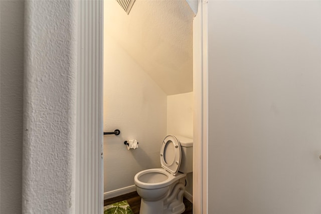 15135 Kamary Ln, San Antonio, TX 78247 - bathroom with toilet, wood finished floors, baseboards, and lofted ceiling