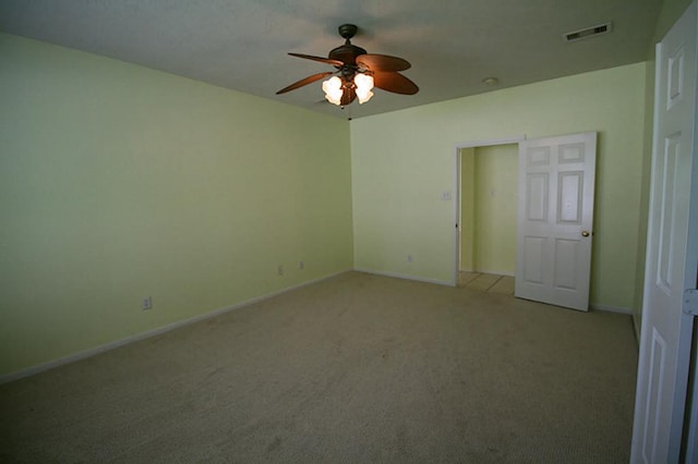 105 N Hollylaurel Cir, The Woodlands, TX 77382 - unfurnished bedroom featuring light colored carpet, baseboards, and ceiling fan