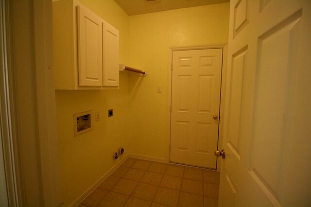105 N Hollylaurel Cir, The Woodlands, TX 77382 - washroom featuring hookup for an electric dryer, cabinet space, light tile patterned flooring, washer hookup, and baseboards