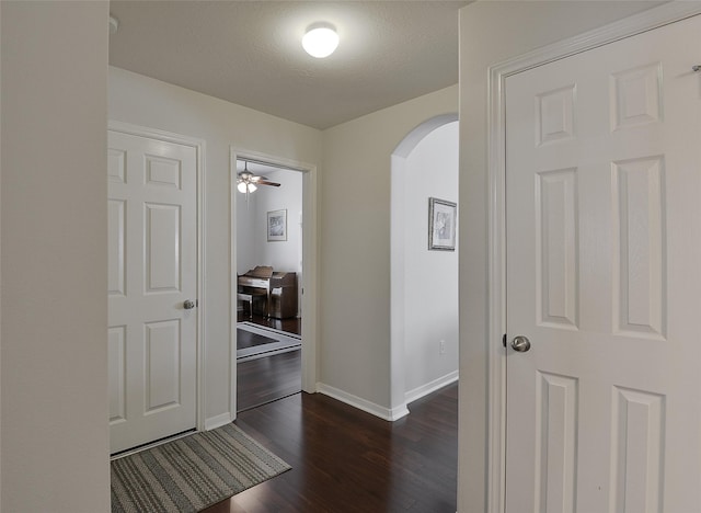 8810 Sailing Dr, Humble, TX 77346 - hall featuring arched walkways, dark wood-type flooring, and baseboards