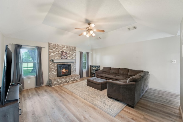 31047 Torrey Rd, Waller, TX 77484 - living room with a ceiling fan, wood finished floors, lofted ceiling, a brick fireplace, and baseboards