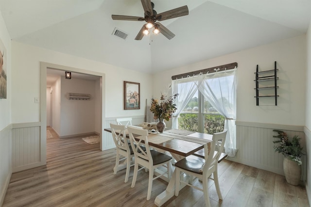 31047 Torrey Rd, Waller, TX 77484 - dining space featuring lofted ceiling, wainscoting, light wood-style floors, and ceiling fan
