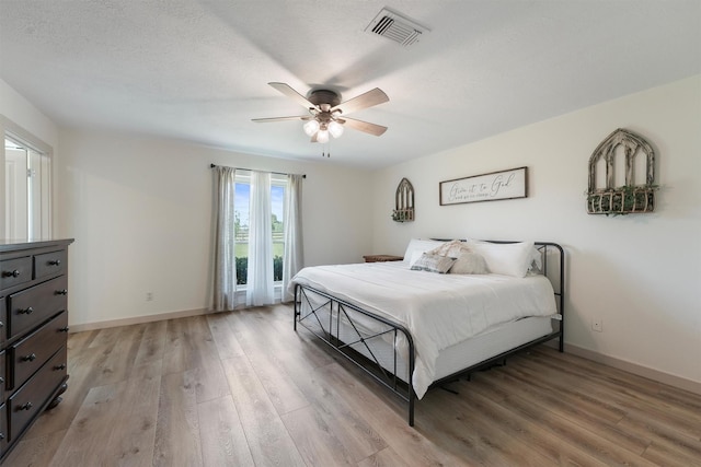 31047 Torrey Rd, Waller, TX 77484 - bedroom with light wood-type flooring, baseboards, and a ceiling fan