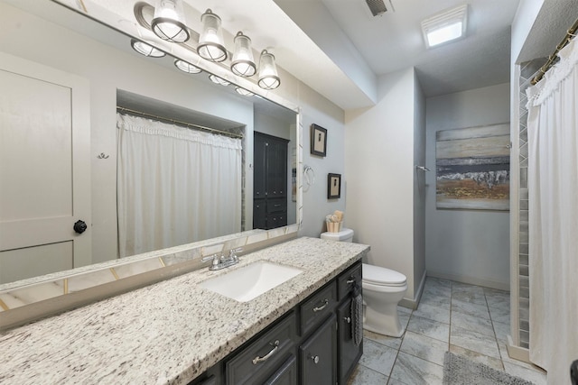 31047 Torrey Rd, Waller, TX 77484 - full bath featuring vanity, toilet, stone tile flooring, and baseboards