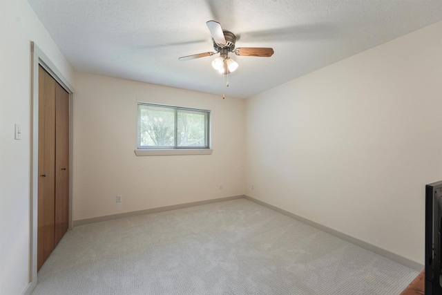 31047 Torrey Rd, Waller, TX 77484 - unfurnished bedroom featuring light colored carpet, a closet, baseboards, and ceiling fan