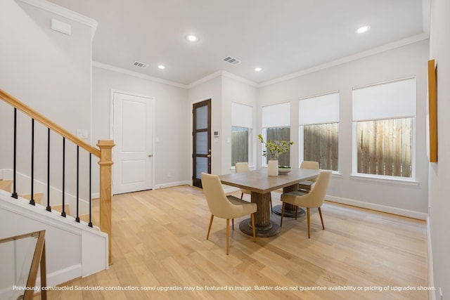 1818 Colquitt St, Houston, TX 77098 - dining space with baseboards, wood finished floors, stairs, crown molding, and recessed lighting