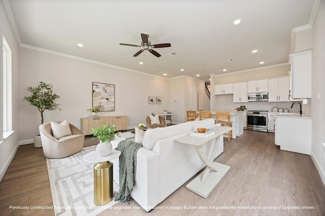 1818 Colquitt St, Houston, TX 77098 - living area with wood finished floors, ceiling fan, recessed lighting, crown molding, and baseboards