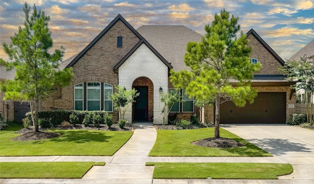 15240 Hemingway Heights Dr, Conroe, TX 77302 - french country style house with concrete driveway, a garage, brick siding, and stone siding