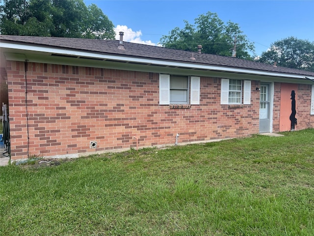 2991 Mimosa Ln, Huntsville, TX 77320 - view of side of property with a lawn and brick siding