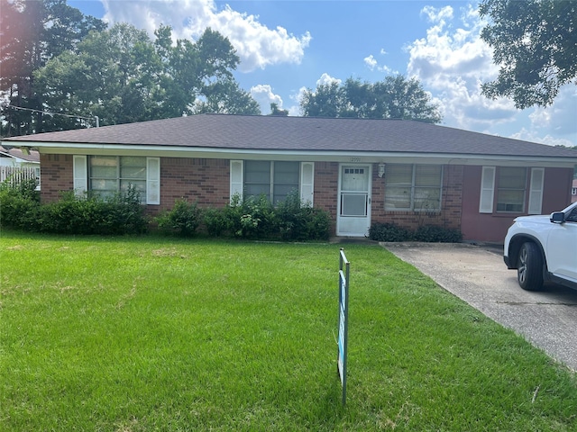 2991 Mimosa Ln, Huntsville, TX 77320 - ranch-style home with brick siding, a front yard, and roof with shingles
