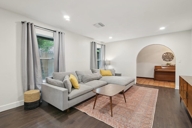 6222 Queensloch Dr, Houston, TX 77096 - living area with arched walkways, dark wood-type flooring, recessed lighting, and baseboards