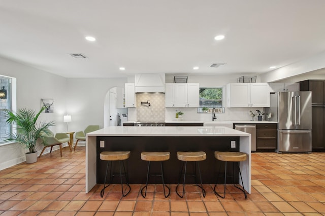 6222 Queensloch Dr, Houston, TX 77096 - kitchen with stainless steel appliances, custom exhaust hood, light countertops, a center island, and recessed lighting