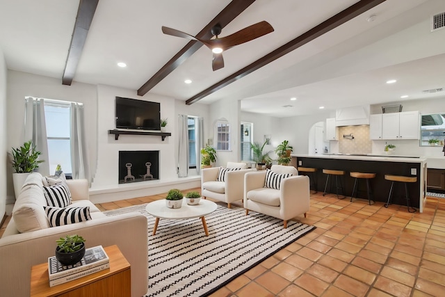 6222 Queensloch Dr, Houston, TX 77096 - living area with beam ceiling, a ceiling fan, recessed lighting, and light tile patterned floors