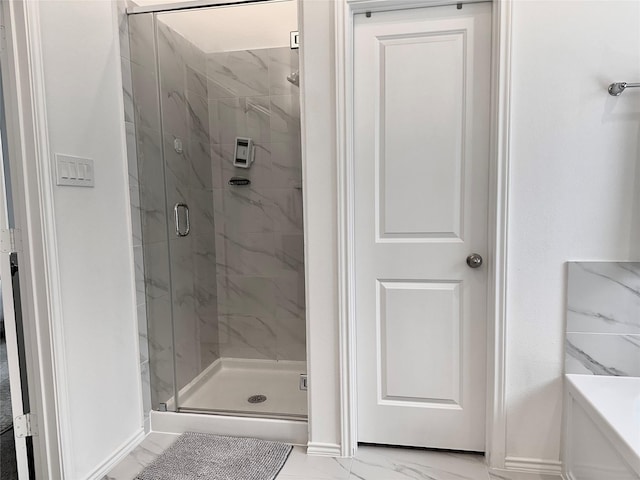 7419 Caprock Canyon Ln, Porter, TX 77365 - bathroom with marble finish flooring, a marble finish shower, and baseboards