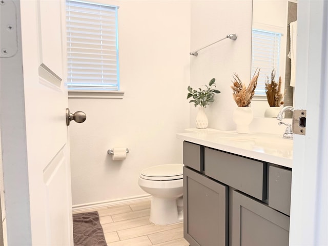 7419 Caprock Canyon Ln, Porter, TX 77365 - bathroom featuring vanity, toilet, wood finished floors, and baseboards