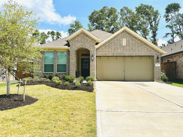 7419 Caprock Canyon Ln, Porter, TX 77365 - view of front of home with brick siding, an attached garage, driveway, a front yard, and a shingled roof