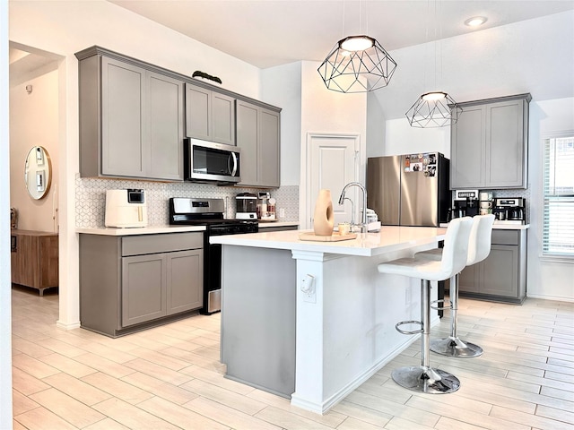 7419 Caprock Canyon Ln, Porter, TX 77365 - kitchen with appliances with stainless steel finishes, gray cabinets, and backsplash