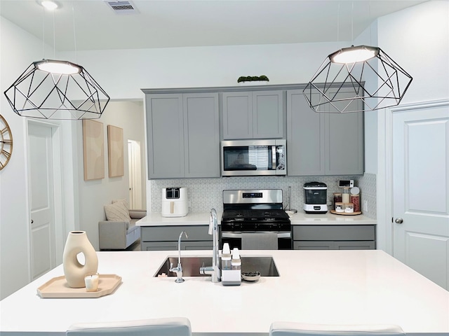 7419 Caprock Canyon Ln, Porter, TX 77365 - kitchen with stainless steel appliances, gray cabinets, and light countertops