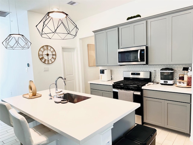 7419 Caprock Canyon Ln, Porter, TX 77365 - kitchen with appliances with stainless steel finishes, gray cabinets, and a sink