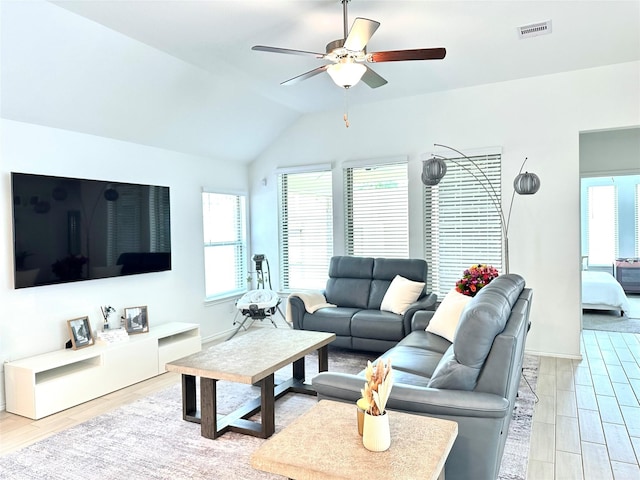 7419 Caprock Canyon Ln, Porter, TX 77365 - living room featuring plenty of natural light, a ceiling fan, lofted ceiling, light wood-style flooring, and baseboards