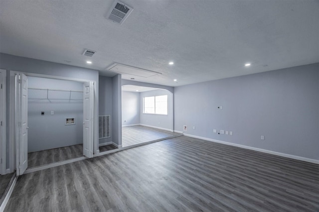 11919 Bald Mountain Cir, Houston, TX 77067 - unfurnished room featuring wood finished floors, attic access, baseboards, recessed lighting, and a textured ceiling