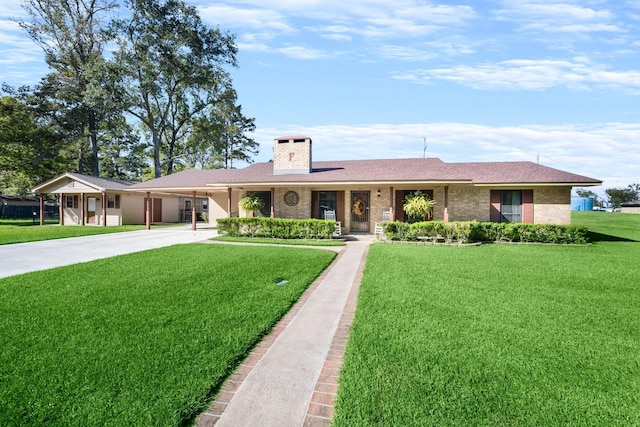 213 Cobb St, Corrigan, TX 75939 - ranch-style home featuring concrete driveway, a front yard, an attached carport, a chimney, and brick siding